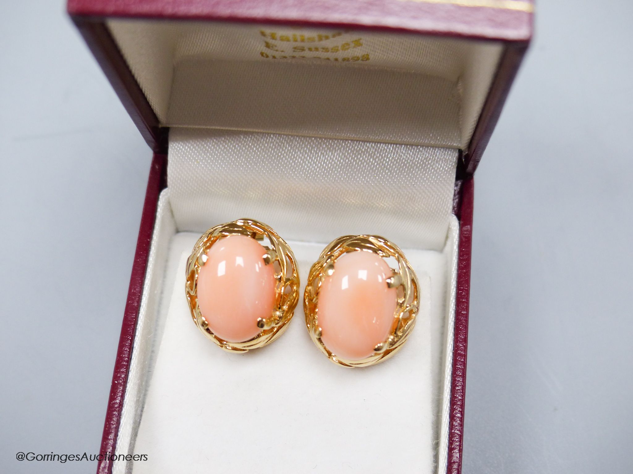 A modern pair of yellow metal (stamped 14k) and oval coral bead earrings, 16mm